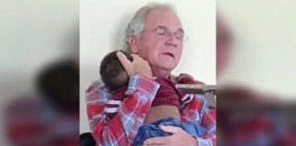 Žena fotografirala čovjeka kako drži tuđe dijete